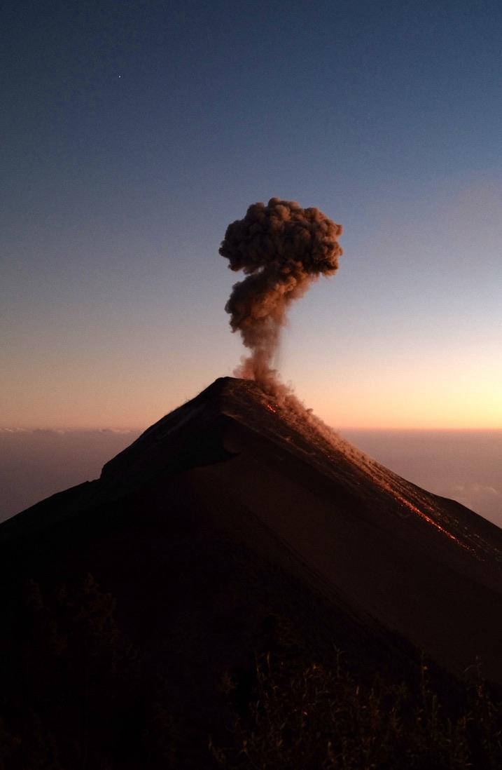 A volcano erupting at dusk
