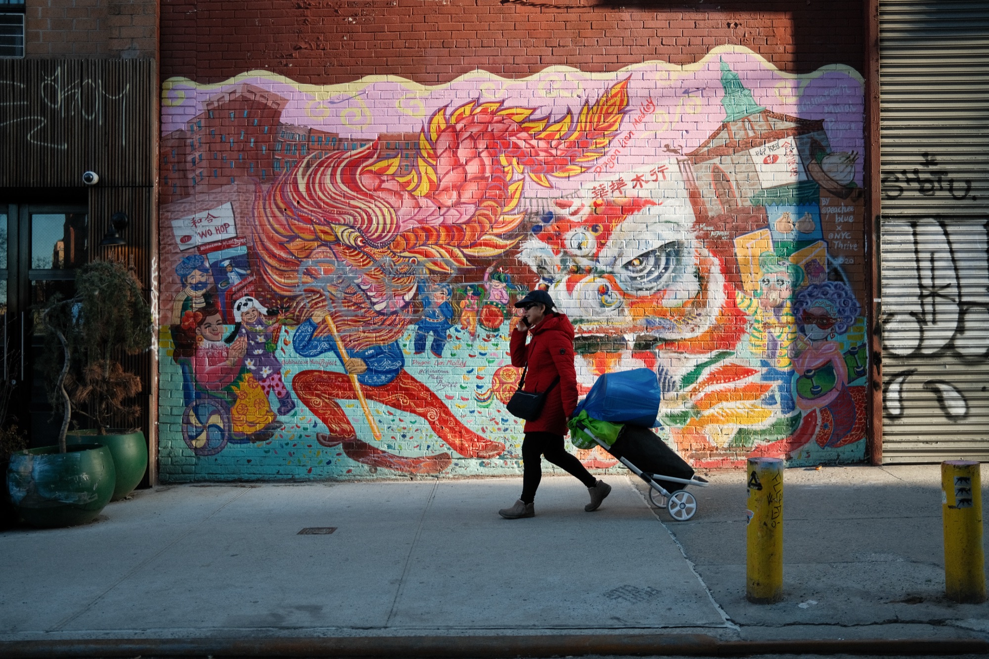 A woman walking past a colourful mural